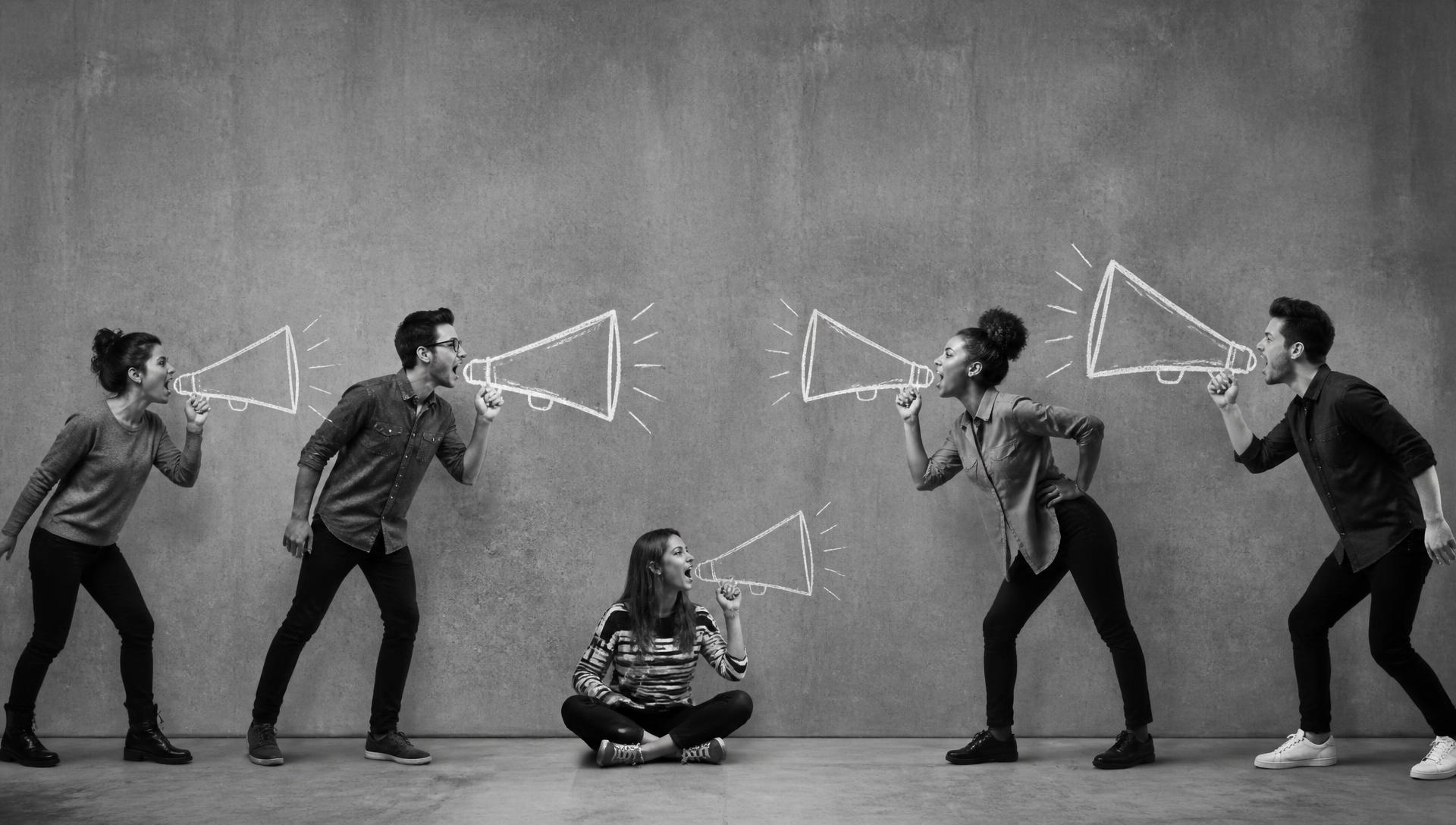 People shouting through illustrated megaphones against a concrete wall